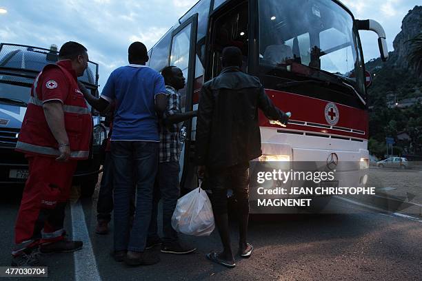 Group of migrants get on a bus provided by the Croce Rossa Italiana to leave the Italian-French border of Ventimiglia, on June 2015. Italian police...