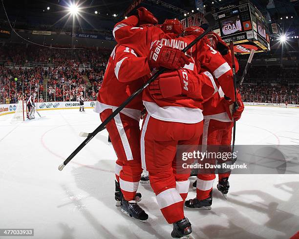 Jonathan Ericsson, Todd Bertuzzi, Drew Miller and Joakim Andersson of the Detroit Red Wings surround teammate Niklas Kronwall after scoring a goal...