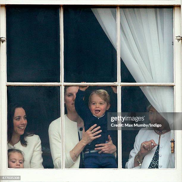 Prince George of Cambridge being held up at a window of Buckingham Palace by his nanny Maria Teresa Turrion Borrallo to watch Trooping the Colour on...