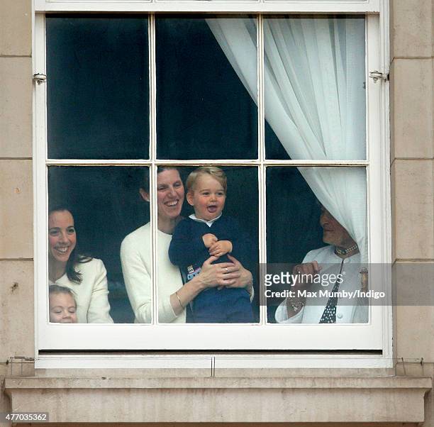 Prince George of Cambridge being held up at a window of Buckingham Palace by his nanny Maria Teresa Turrion Borrallo to watch Trooping the Colour on...