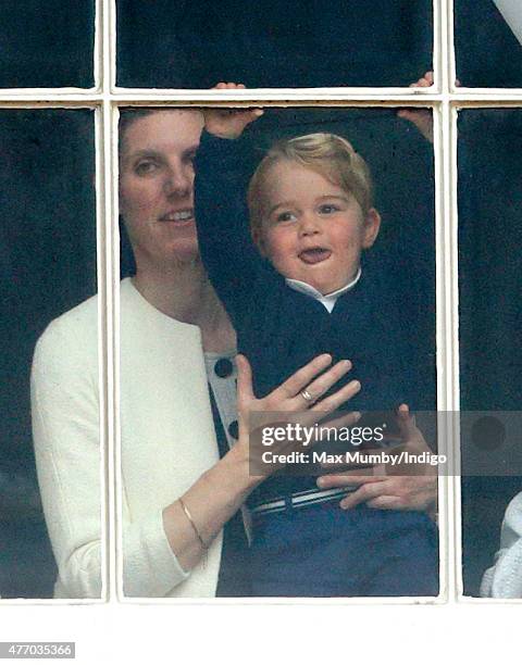 Prince George of Cambridge being held up at a window of Buckingham Palace by his nanny Maria Teresa Turrion Borrallo to watch Trooping the Colour on...