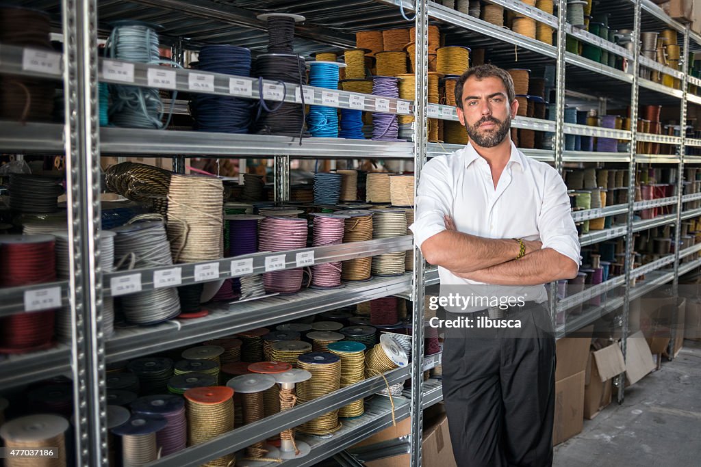 Young man in his artisanal handicraft traditional textile factory