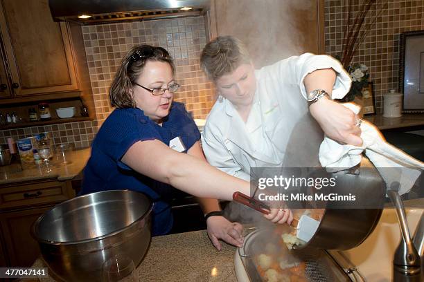 Team preparing their recipe at the Milwaukee Recipe Refresh Challenge at Il Mito Restaurant on March 06, 2014 in Wauwatosa, Wisconsin.