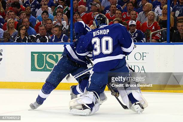Ben Bishop of the Tampa Bay Lightning collides with Victor Hedman in the first period against the Chicago Blackhawks Game Five of the 2015 NHL...