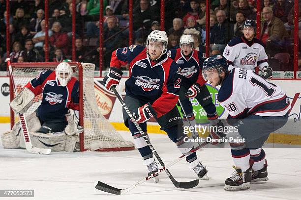 Eric Diodati of the Windsor Spitfires skates against Dylan Sadowy of the Saginaw Spirit on March 6, 2014 at the WFCU Centre in Windsor, Ontario,...