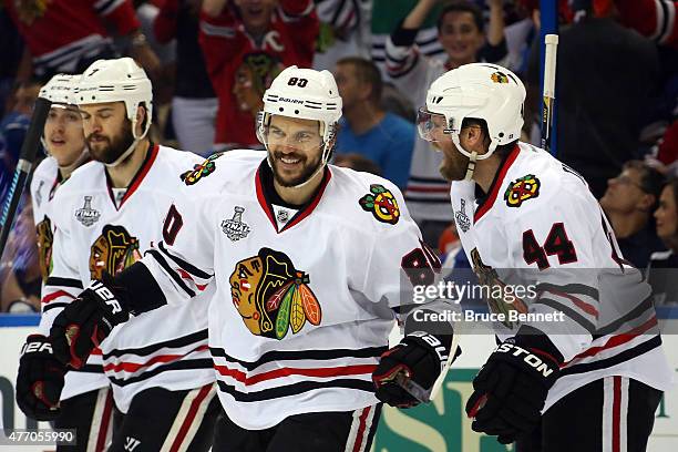 Antoine Vermette of the Chicago Blackhawks celebrates with Kimmo Timonen after scoring a goal in the third period against the Tampa Bay Lightning...