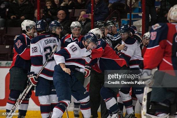Dylan Sadowy of the Saginaw Spirit takes a fight with Eric Diodati of the Windsor Spitfires on March 6, 2014 at the WFCU Centre in Windsor, Ontario,...