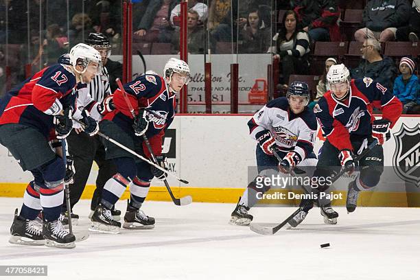 Luke Cairns of the Saginaw Spirit battles for the puck against Nikita Yazkov of the Windsor Spitfires on March 6, 2014 at the WFCU Centre in Windsor,...