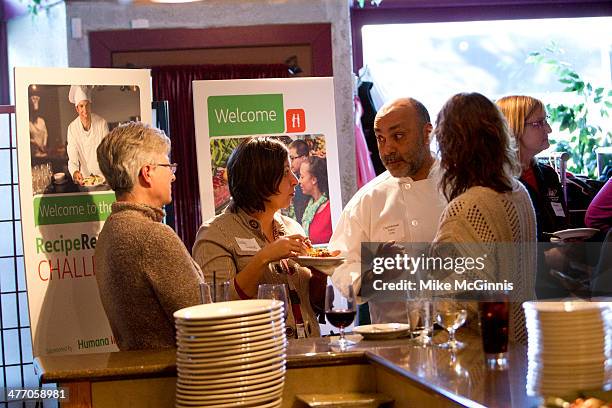 Guests and chefs socialize before the start of the Milwaukee Recipe Refresh Challenge at Il Mito Restaurant on March 06, 2014 in Wauwatosa, Wisconsin.