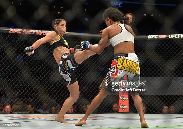 Tecia Torres of the United States kicks Angela Hill of the United States in their women's strawweight bout during the UFC 188 event at the Arena...
