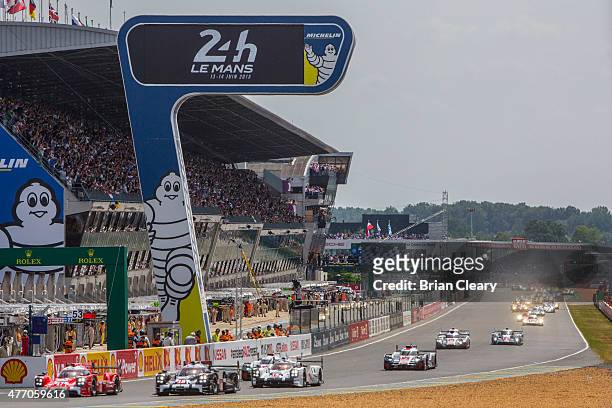 Cars race into the first turn at the start of the 24 Hour of Lemans on June 13, 2015 in Le Mans, France.