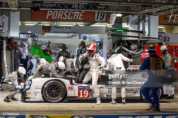 The Porsche 919 Hybrid of Nico Hulkenburg, Earl Bamber, and Nick Tandy makes a pit stop during the 24 Hour of Lemans on June 13, 2015 in Le Mans,...