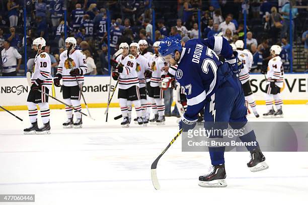 Jonathan Drouin of the Tampa Bay Lightning skates off the ice as the Chicago Blackhawks celebrate defeating Tampa Bay Lightning 2 to 1 during Game...