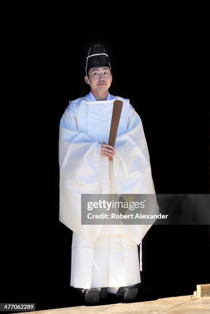 Shinto priest stands during a ceremony at the Meiji-Jingu shrine in the Harajuku district of Tokyo. The shrine and surrounding gardens are dedicated...