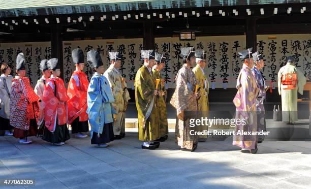 Shinto priests prepare to participate in a ceremony at the Meiji-Jingu shrine in the Harajuku district of Tokyo. The shrine and surrounding gardens...