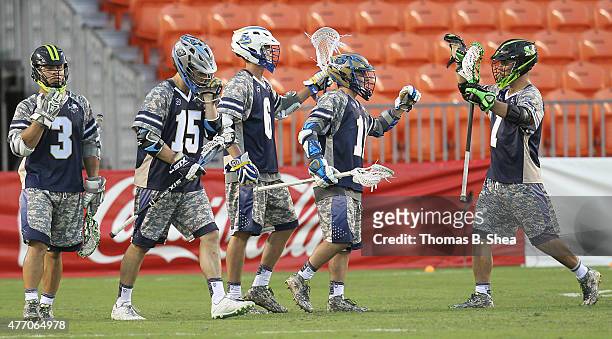Kieran McArdle of the Cowboys celebrates his goal with teammates against the Gladiators in the second half during the 2015 MLL All Star Game on June...