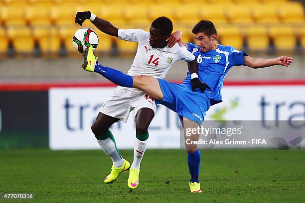 Moussa Kone of Senegal is challenged by Akramjon Komilov of Uzbekistan during the FIFA U-20 World Cup New Zealand 2015 Quarter Final match between...