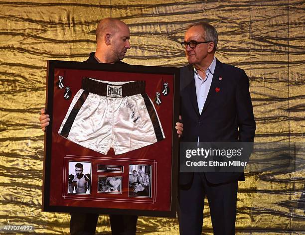 Keep Memory Alive Founder and Chairman Larry Ruvo auctions off Muhammad Ali's boxing trunks from his "Thrilla in Manila" bout against Joe Frazier...