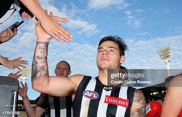 Jamie Elliott of the Magpies high fives fans after winning the round 11 AFL match between the Collingwood Magpies and the Greater Western Sydney...