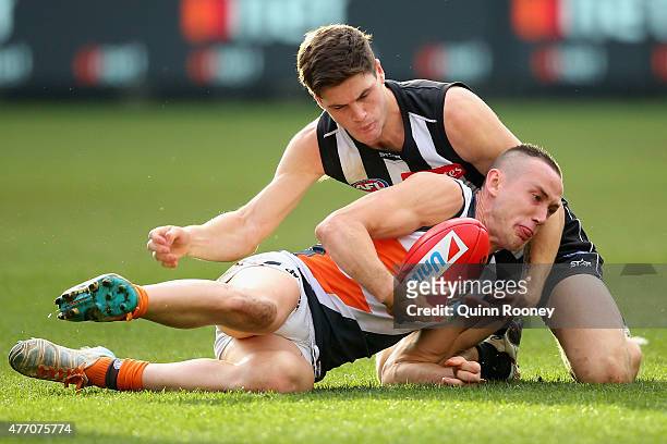 Tom Scully of the Giants and Jack Crisp of the Magpies compete for the ball during the round 11 AFL match between the Collingwood Magpies and the...