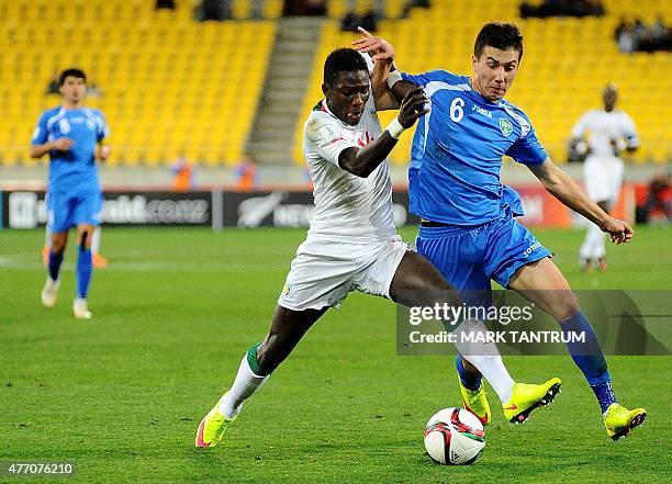 Moussa Kone of Senegal fights for the ball with Akramjon Komilov of Uzbekistan during the FIFA Under-20 World Cup football quarter-final match...