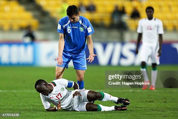 Akramjon Komilov of Uzbekistan appeals to Roger Gomis of Senegal after going down injured during the FIFA U-20 World Cup New Zealand 2015...