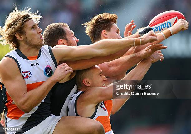 Nick Haynes of the Giants spoils a mark by Travis Cloke of the Magpies during the round 11 AFL match between the Collingwood Magpies and the Greater...