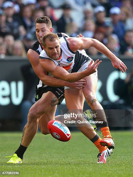 Jesse White of the Magpies and Joel Patfull of the Giants compete for the ball during the round 11 AFL match between the Collingwood Magpies and the...