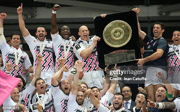 Sergio Parisse and Pierre Rabadan of Stade Francais lift the 'Bouclier de Brennus' during the trophy ceremony following the Top 14 Final between ASM...