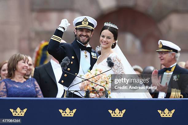 Prince Carl Philip of Sweden and HRH Princess Sofia, Duchess of Varmlands salute the crowd after their marriage ceremony on June 13, 2015 in...