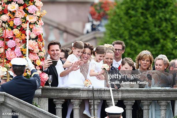 Guests attend the arrival of Prince Carl Philip of Sweden and Princess Sofia, Duchess of Varmlands at the Royal Palace after their marriage ceremony...