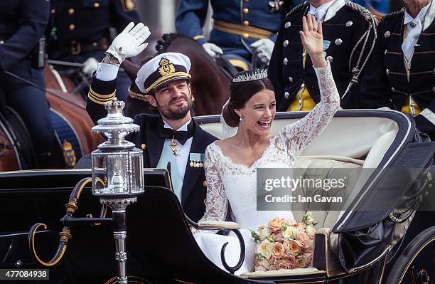 Prince Carl Philip of Sweden and his wife Princess Sofia of Sweden ride in the wedding cortege after their marriage ceremony on June 13, 2015 in...