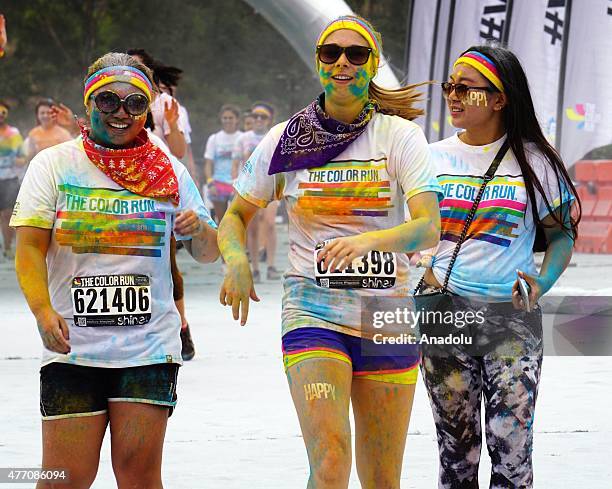 Revelers throw colored powder and dance during "Color Sky 5k" running fest at Dodger Stadium in Los Angeles, CA on June 13, 2015.