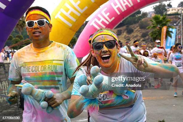 Revelers throw colored powder and dance during "Color Sky 5k" running fest at Dodger Stadium in Los Angeles, CA on June 13, 2015.