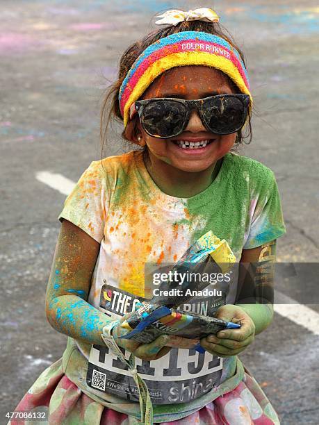 Revelers throw colored powder and dance during "Color Sky 5k" running fest at Dodger Stadium in Los Angeles, CA on June 13, 2015.