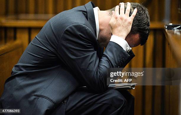 South African paralympic athlete Oscar Pistorius gestures in the dock on the fifth day of his trial for the 2013 murder of his girlfriend Reeva...