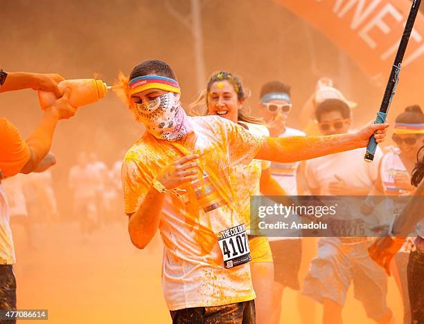 Revelers throw colored powder and dance during "Color Sky 5k" running fest at Dodger Stadium in Los Angeles, CA on June 13, 2015.