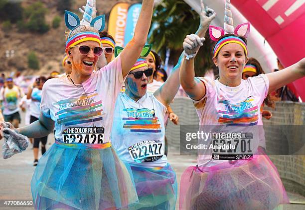 Revelers throw colored powder and dance during "Color Sky 5k" running fest at Dodger Stadium in Los Angeles, CA on June 13, 2015.