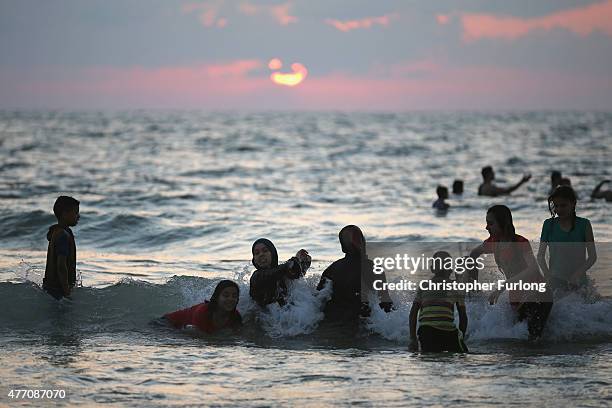 Palastinians enjoy a dip in the ocean at Gaza beach on June 13, 2015 in Gaza City, Gaza. Palestinians are taking the opportunity to relax and enjoy...