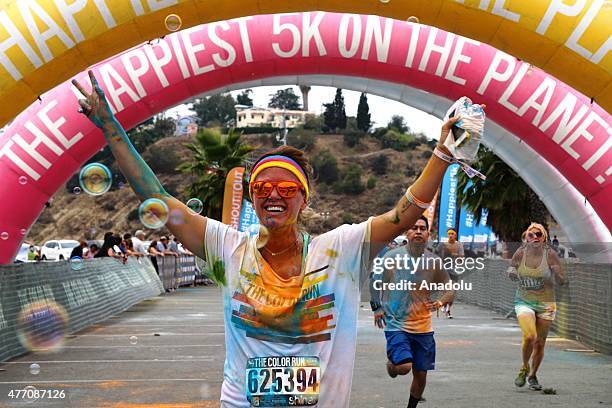 Revelers throw colored powder and dance during "Color Sky 5k" running fest at Dodger Stadium in Los Angeles, CA on June 13, 2015.