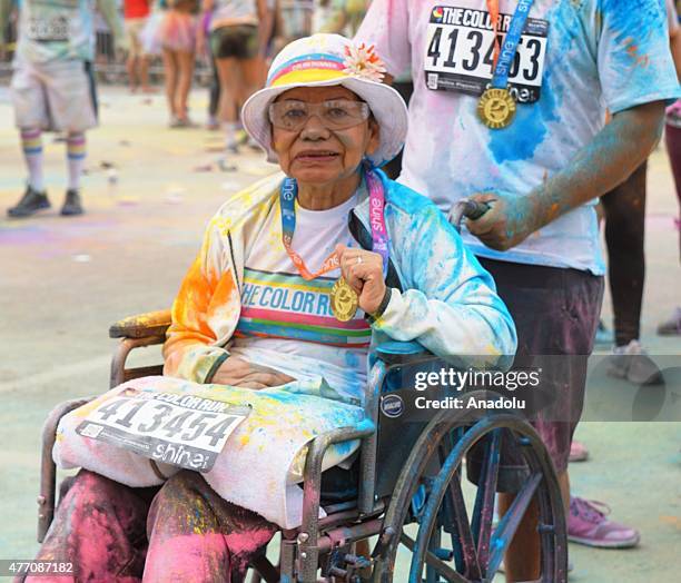 Revelers throw colored powder and dance during "Color Sky 5k" running fest at Dodger Stadium in Los Angeles, CA on June 13, 2015.