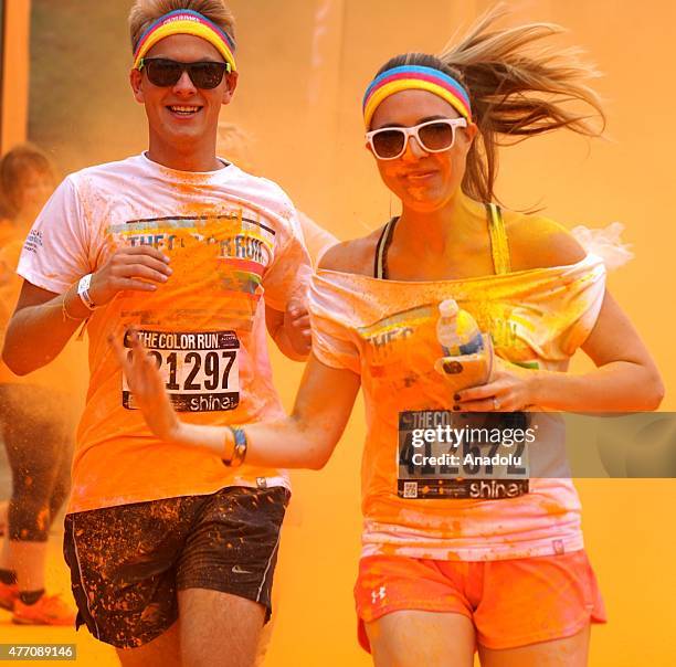 Revelers throw colored powder and dance during "Color Sky 5k" running fest at Dodger Stadium in Los Angeles, CA on June 13, 2015.