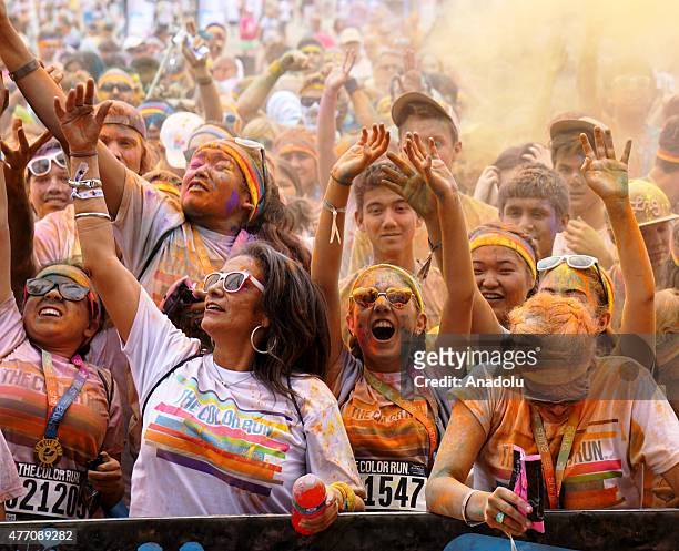Revelers throw colored powder and dance during "Color Sky 5k" running fest at Dodger Stadium in Los Angeles, CA on June 13, 2015.