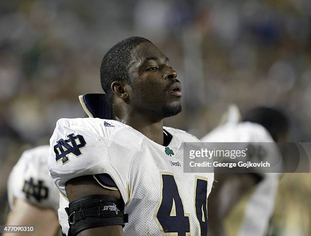 Defensive lineman Justin Tuck of the Notre Dame Fighting Irish looks on from the sideline during a college football game against the University of...