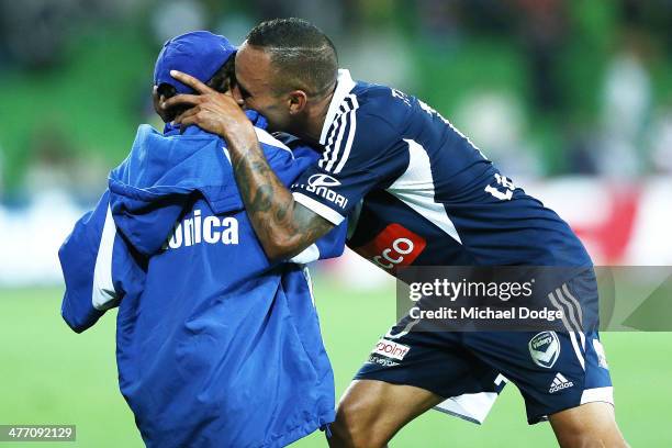 Archie Thompson of the Victory celebrates a team goal by by kissing his Axel Thompson during the round 22 A-League match between Melbourne Victory...