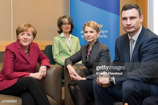 In this photo provided by the German Government Press Office , German Chancellor Angela Merkel speaks with Ukranian Politicians Julia Timoschenko...