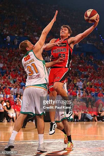Damian Martin of the Wildcats laysup against Jacob Holmes of the Crocodiles during the round 21 NBL match between the Perth Wildcats and the...