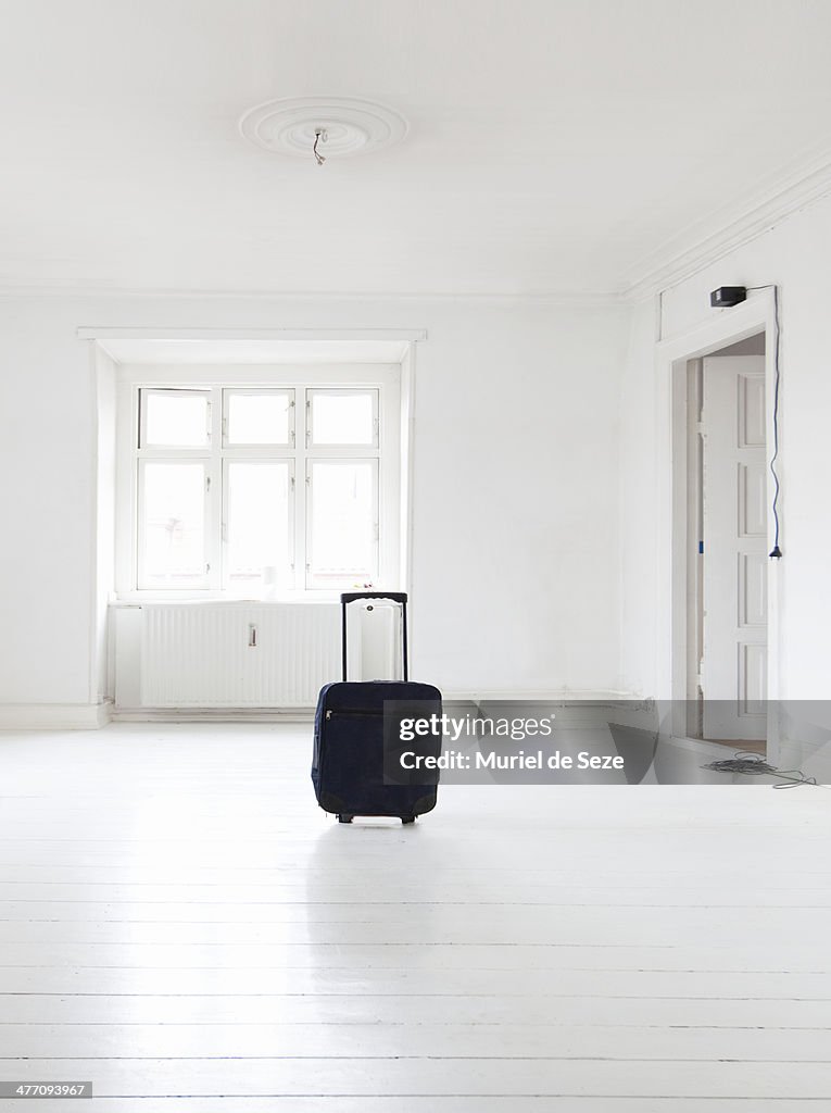 Suitcase in empty apartment