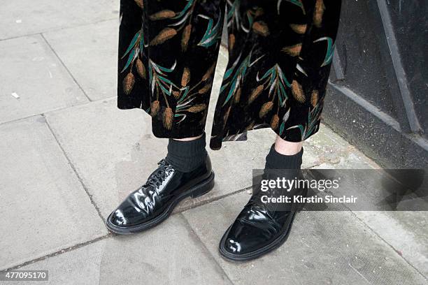 Fashion and accessories designer Simon Peters wears a Chin Wang suit, Issey Miyake top and Saint Laurent shoes on day 2 of London Collections: Men on...