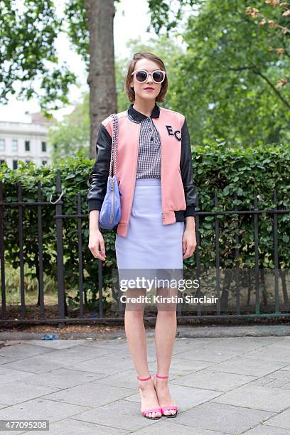 Model and fashion blogger Ella Catliff wears a Whistles jacket, Rebecca Minkoff bag, Carven shirt, Holly Cullen skirt and Kurt Geiger shoes on day 2...